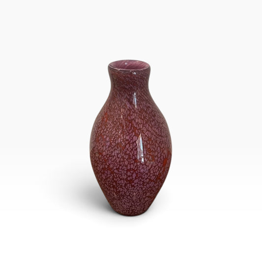 Small pink, spotted glass vessel with narrow neck.